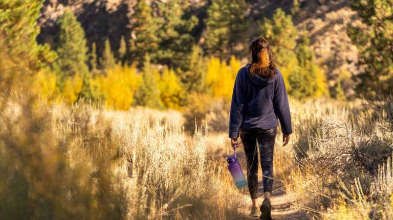 Woman hiking through forest