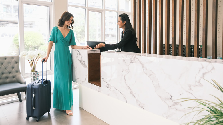 Woman checking into a hotel