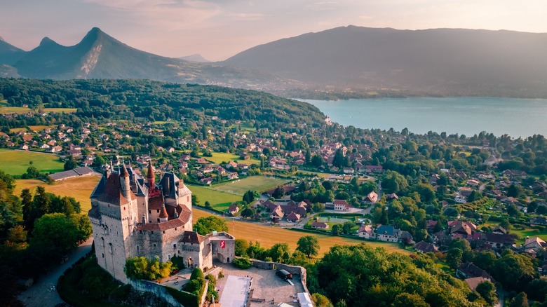 castle overlooking lake and mountains