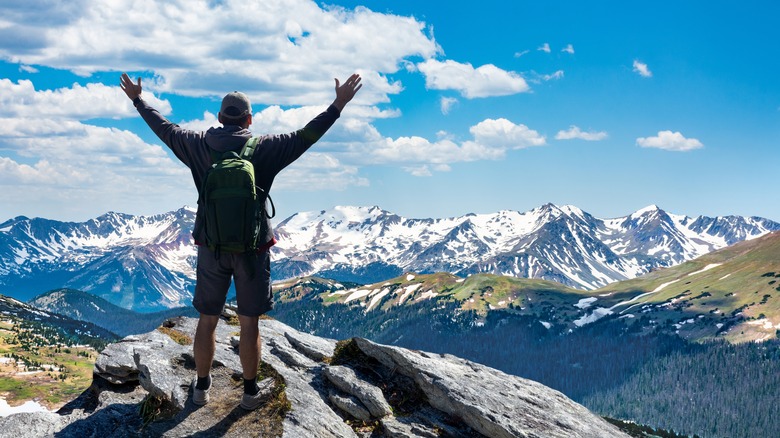 hiker rocks snowy mountains