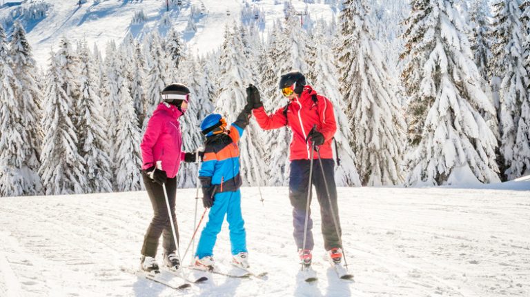 skiing family high-five