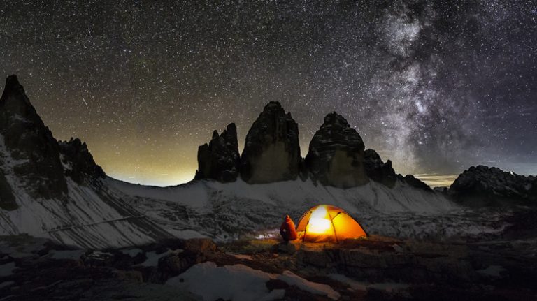 A camper wearing a headlamp