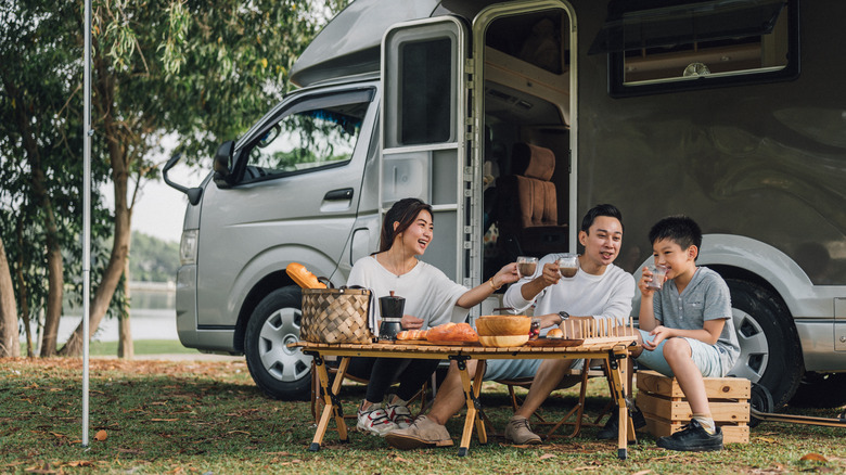 A family enjoying coffee near RV