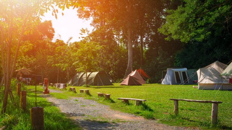 Morning sunrise at a campground with multiple tents set up