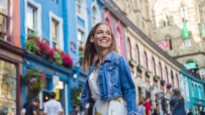 Smiling woman exploring in Edinburgh