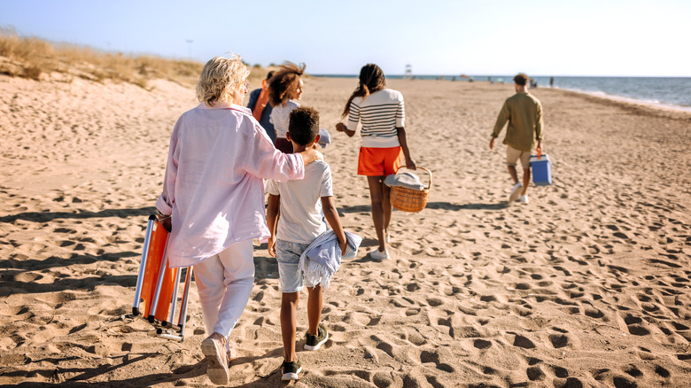 people carrying stuff on beach