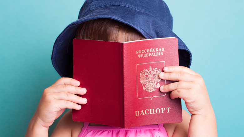 toddler holding passport