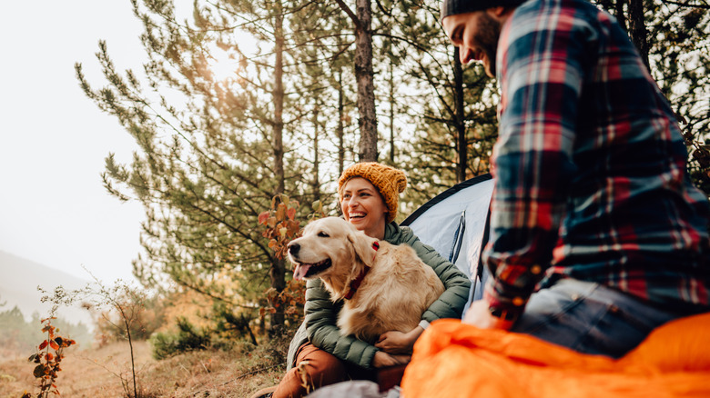 couple with dog outdoors