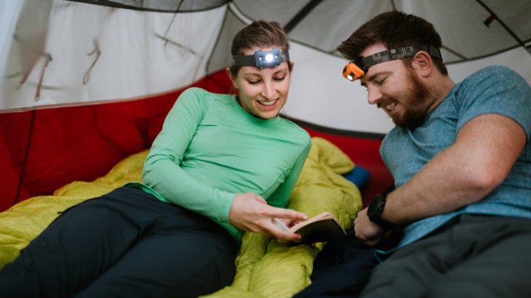 Woman man camping wearing headlamps