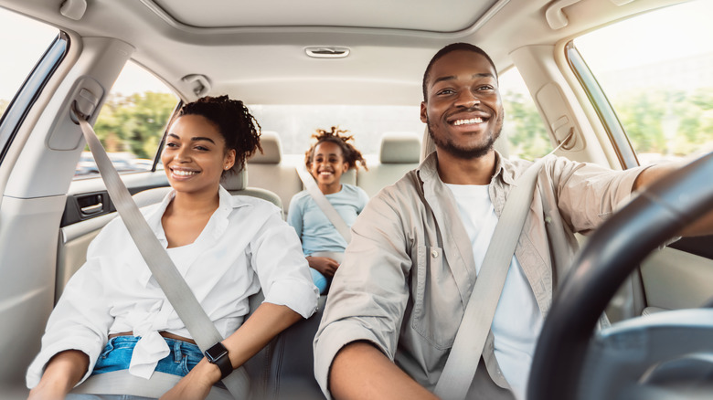 Family smiling in the car