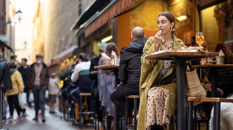 Woman eating alone at restaurant