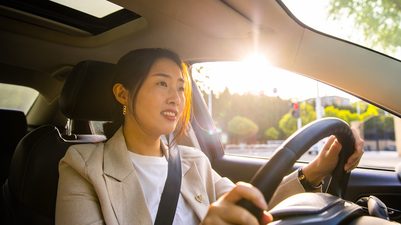 woman smiling and driving