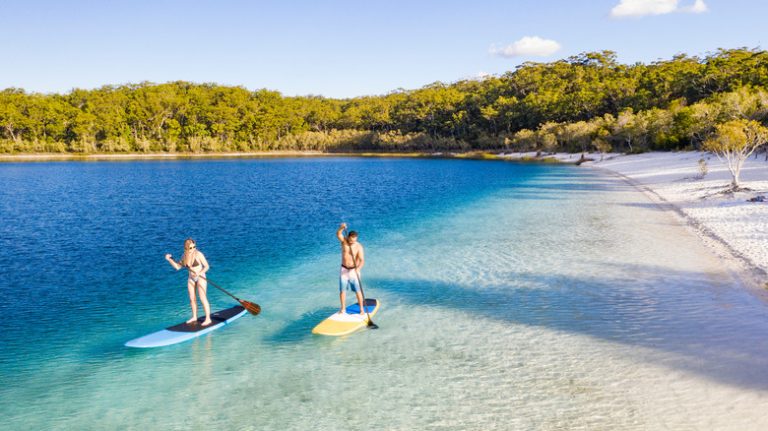 couple paddleboarding at Australian beach