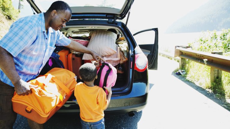 Father and son packing a car for a roadtrip