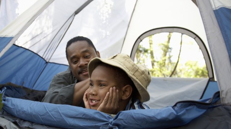 father and son in tent