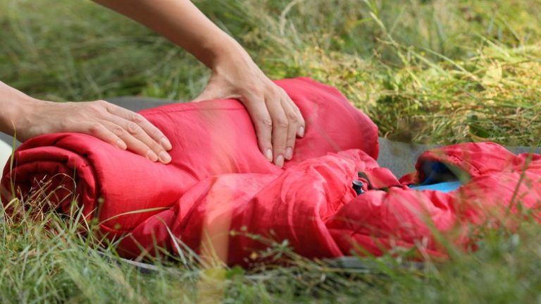 Person rolling a sleeping bag