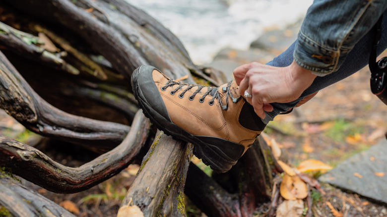 Camper lacing up hiking boots