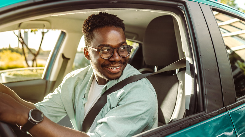 smiling man driving car