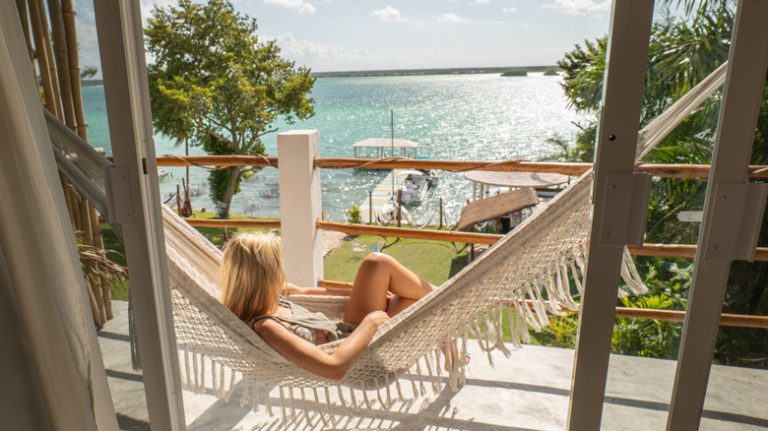 Woman in hammock overlooking Bacalar