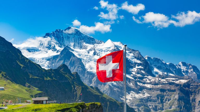 Swiss flag against mountains