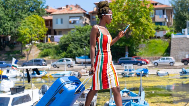 person walking to cruise with luggage