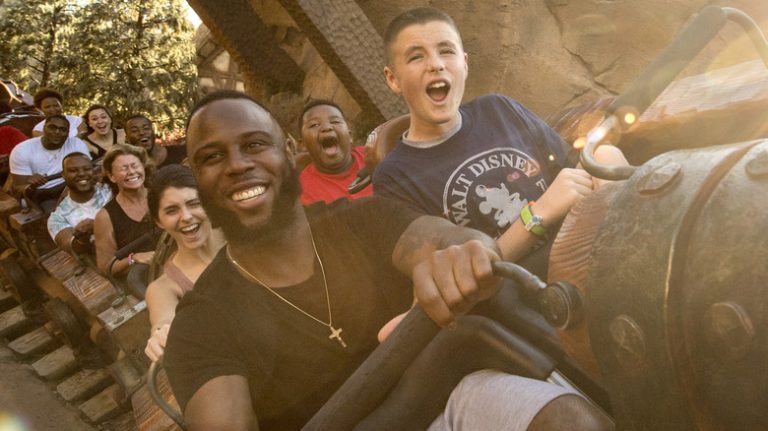 Two men riding a rollercoaster