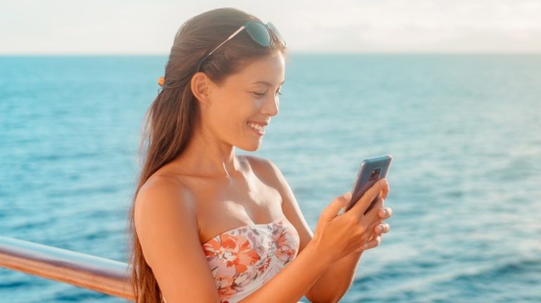 Woman using phone on cruise ship