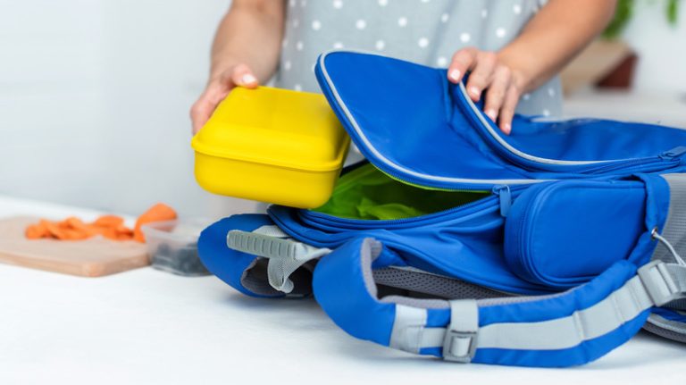 Woman packing blue backpack