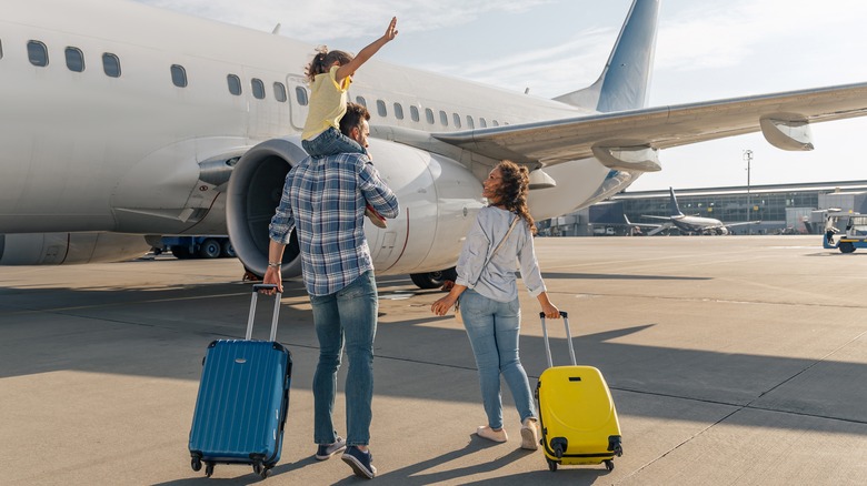 Parents and child by airplane