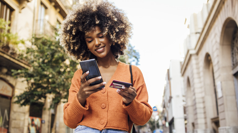 Women holding credit card and phone