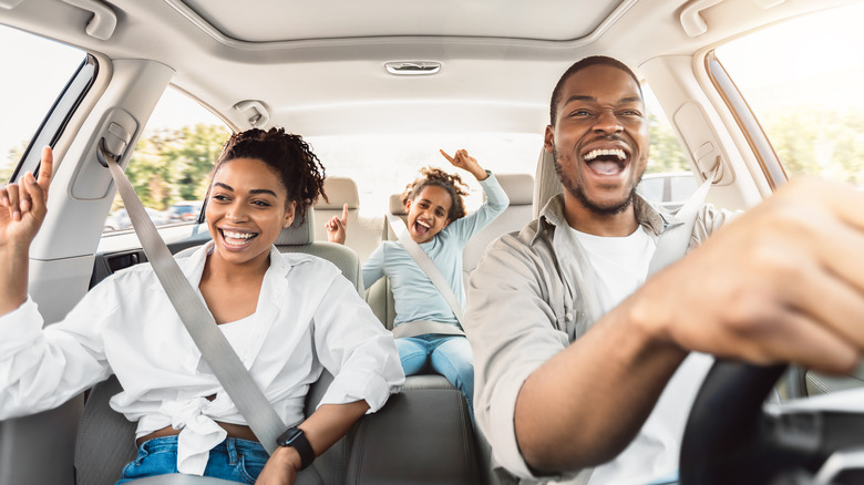 couple and child sitting in car