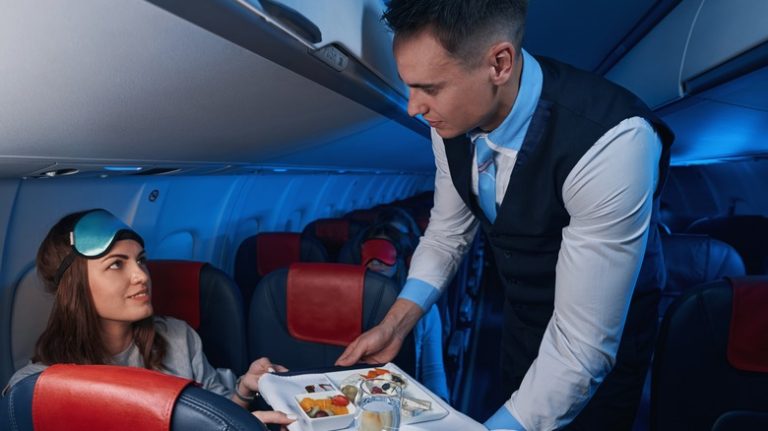 woman looking at flight attendant