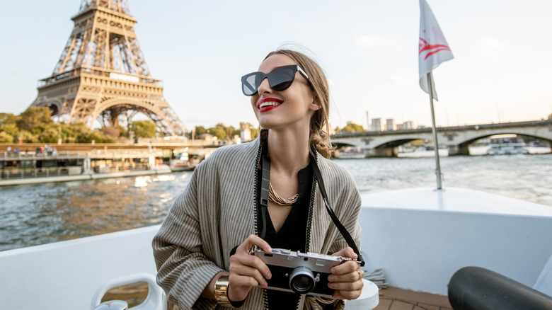 Woman with a camera smiling