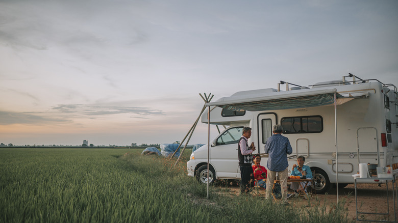 Group relaxing outside an RV