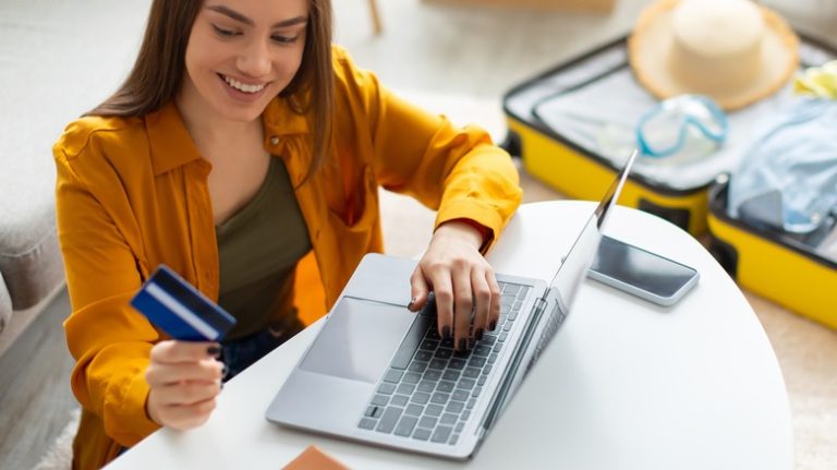 happy traveler woman with credit card